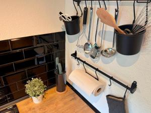 a kitchen counter with a roll of paper towels and utensils at Fewos Herrentor in Emden in Emden +47 photos