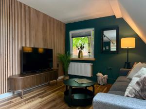 a living room with a couch and a television at Fewos Herrentor in Emden in Emden