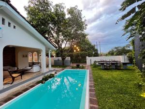 a swimming pool in the backyard of a house at BnB by Month in Weligama