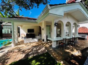a house with a patio and a pool at BnB by Month in Weligama