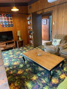 a living room with a table and a couch at Old Mill Park in Bright