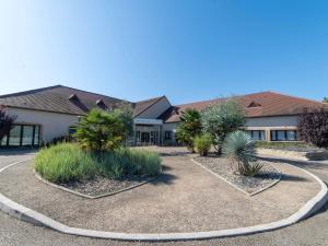 a building with a bunch of plants in front of it at Mercure Auxerre Autoroute du Soleil in Appoigny