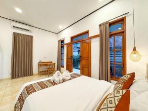 a bedroom with two beds and a desk at Mamo Hotel Uluwatu in Uluwatu +96 photos