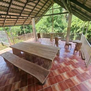 a large wooden table and chairs on a deck at Thota'dha Tent Stay in SanivÄrsante +15 photos