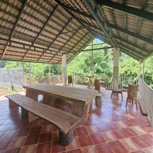 a large wooden table sitting on top of a patio at Thota'dha Tent Stay in SanivÄrsante