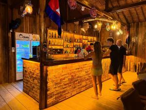 a group of people standing at a bar at Sand and Sun Koh Rong in Kaôh Rŭng +29 photos