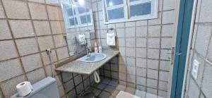a bathroom with a sink and a toilet at Casa Cabugi Ponta Negra JR in Natal +29 photos