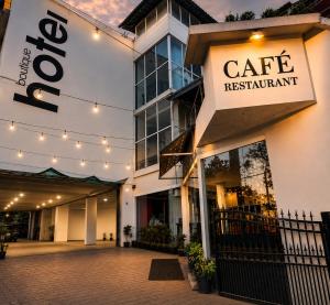 a building with a cafe restaurant sign on it at Cosset - A Boutique Hotel in Lonavala