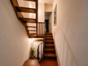 a staircase in a home with a wooden stair case at La Maison de Verdun in Sainte-Maxime