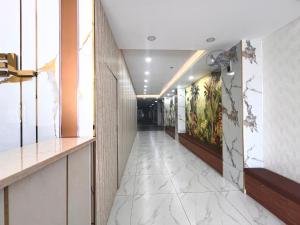 a corridor of a hotel with marble floors and walls at Glory Hotel in Can Tho