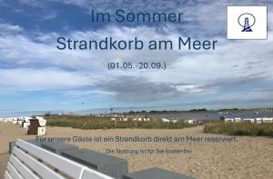 a beach with a sign that says im summer standoffoit an meter at Ferienwohnung Ritthoff Perlebucht - mit Strandkorb am Meer und kostenloser Eintritt ins Schwimmbad in Büsum