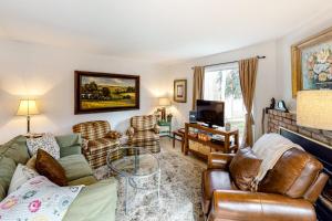 a living room with a couch and chairs and a tv at Snowmass Village 14A in Snowmass Village