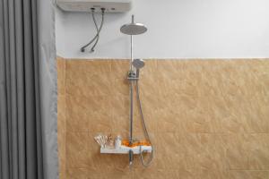 a shower in a bathroom with a shelf on the wall at Aby Guest House in Sidemen +57 photos