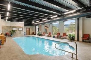a large swimming pool in a building with tables and chairs at The Lodge at Tamarron #425 in Durango