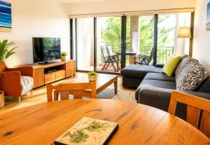 a living room with a couch and a table at Esplanade Views Heart of Freo Family Stay in Fremantle