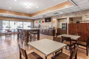 a restaurant with tables and chairs and a kitchen at Quality Inn South Boston - Danville East in South Boston
