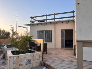 a house with a deck and a building at בית בערבה in Mitzpe Ramon