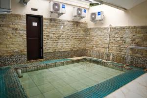 a swimming pool in a room with ailed floor at Nimo Resort Ciater in Ciater