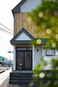 a house with a gate on the front of it at 金木犀 in Kesennuma