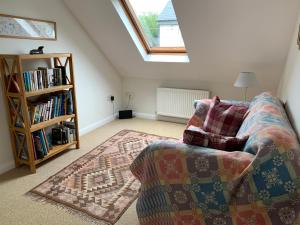 a living room with a couch and a book shelf at Brynawelon in Newport