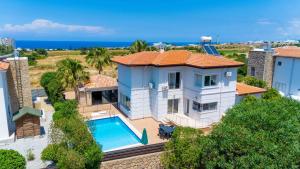 an aerial view of a house with a swimming pool at Poolside Bar Villa Sea Views atalky in Klepini