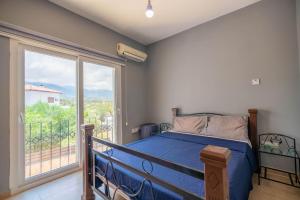 a bedroom with a bed and a large window at Poolside Bar Villa Sea Views atalky in Klepini