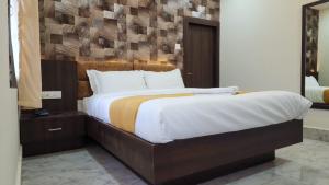 a bedroom with a large bed with a wooden headboard at Dhulikhel Training center in Dhulikhel