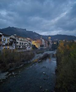 a river in a city with buildings and houses at B&B Giù di sotto in Gavi