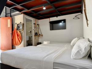 a bedroom with two beds and a flat screen tv at Ardour Lodge "A" Wing in Tanjung Bungah