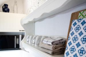 a shelf with towels on it in a kitchen at Möhlenblick in Neustadt in Holstein +22 photos