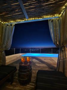 a room with a view of the ocean at night at Villa Aura in Milna