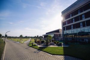 a building with a sidewalk next to a building at Hotel Mariss in Alba Iulia