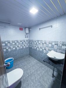 a bathroom with a toilet and a sink at Advik Resort in Badlapur +26 photos