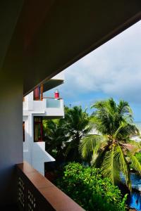 a view from the balcony of a building with palm trees at Buddha Beach Hotel in Kovalam