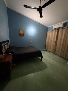 a bedroom with a bed and a ceiling fan at Pakal 2 Apartment in Palenque