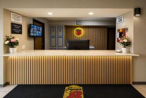 an office lobby with a large wooden counter top at Super 8 by Wyndham Warrenton in Warrenton