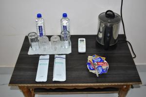 a table with bottles of water and a blender at Bhitarkania Riverside Eco Resorts in Righāgarh