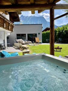 a large swimming pool in a yard with a house at Villa22 Oetz in Oetz