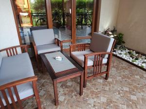 a group of chairs and a table in a room at Blue Marina Sunset in Sozopol +9 photos