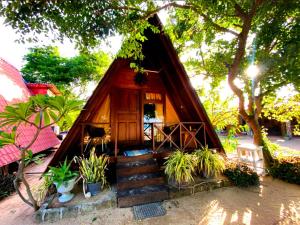 a small house with stairs leading up to it at That's Why Nilaveli Beach Cabanas in Trincomalee