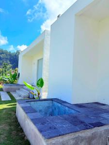 a house with a blue and white wall at Volcano Bliss Villa Kintamani in Kintamani