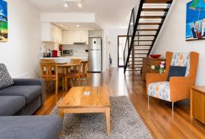 a living room with a couch and a table at Esplanade Views Heart of Freo Family Stay in Fremantle
