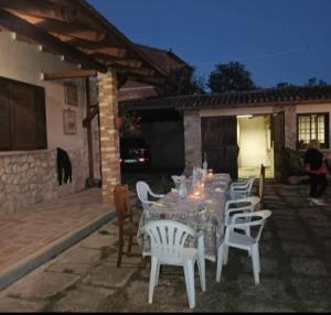 a dining table and chairs on a patio at I colori dell'orizzonte in Santo Stefano