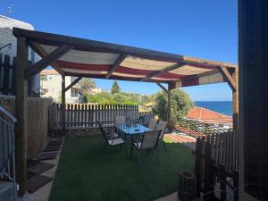 a patio with a table and chairs under a pergola at Koroni Dream House in Koroni