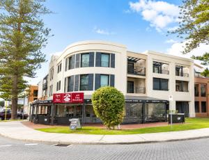 a large white building on the corner of a street at Esplanade Views Heart of Freo Family Stay in Fremantle