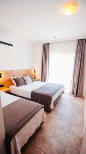 a hotel room with two beds and a window at Costa Sariyaz Hotel Bodrum in Bodrum City +67 photos