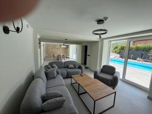 a living room with a couch and chairs and a table at Vila Handžić in Mostar +6 photos