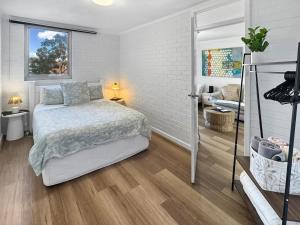 a bedroom with a bed and a living room at Right in Fremantle in Fremantle