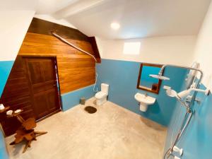 a bathroom with a toilet and a sink at That's Why Nilaveli Beach Cabanas in Trincomalee