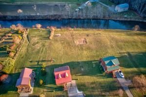 an aerial view of a field with a house and a river at New River Ramble in Todd